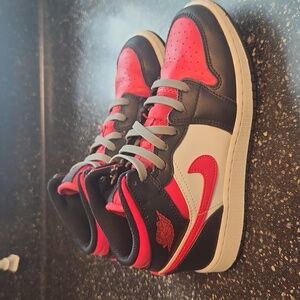 Black, red, and white nike Kids sneakers